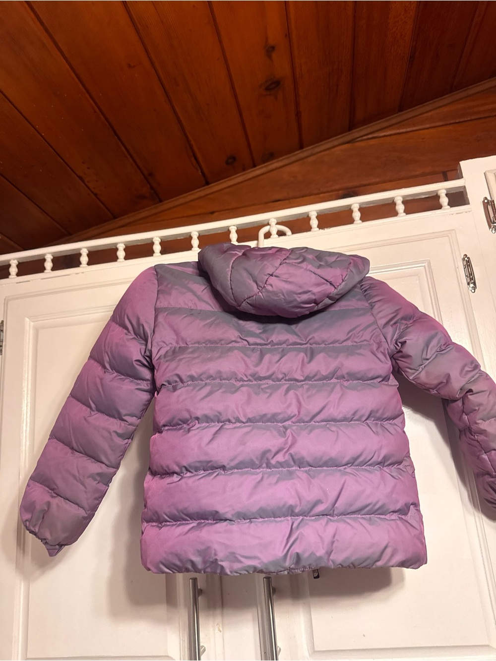 The North Face reversible down jacket featuring a purple iridescent finish